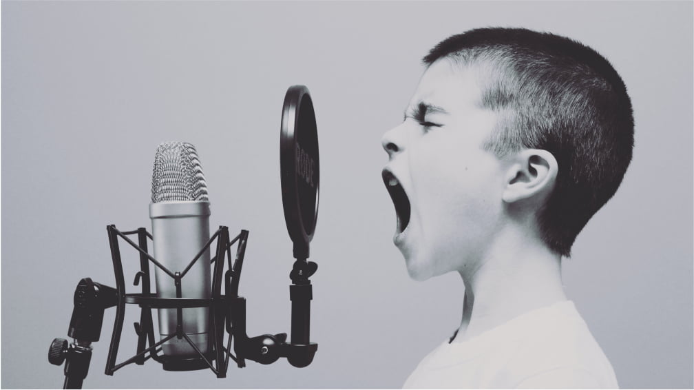Child singing in front of a microphone