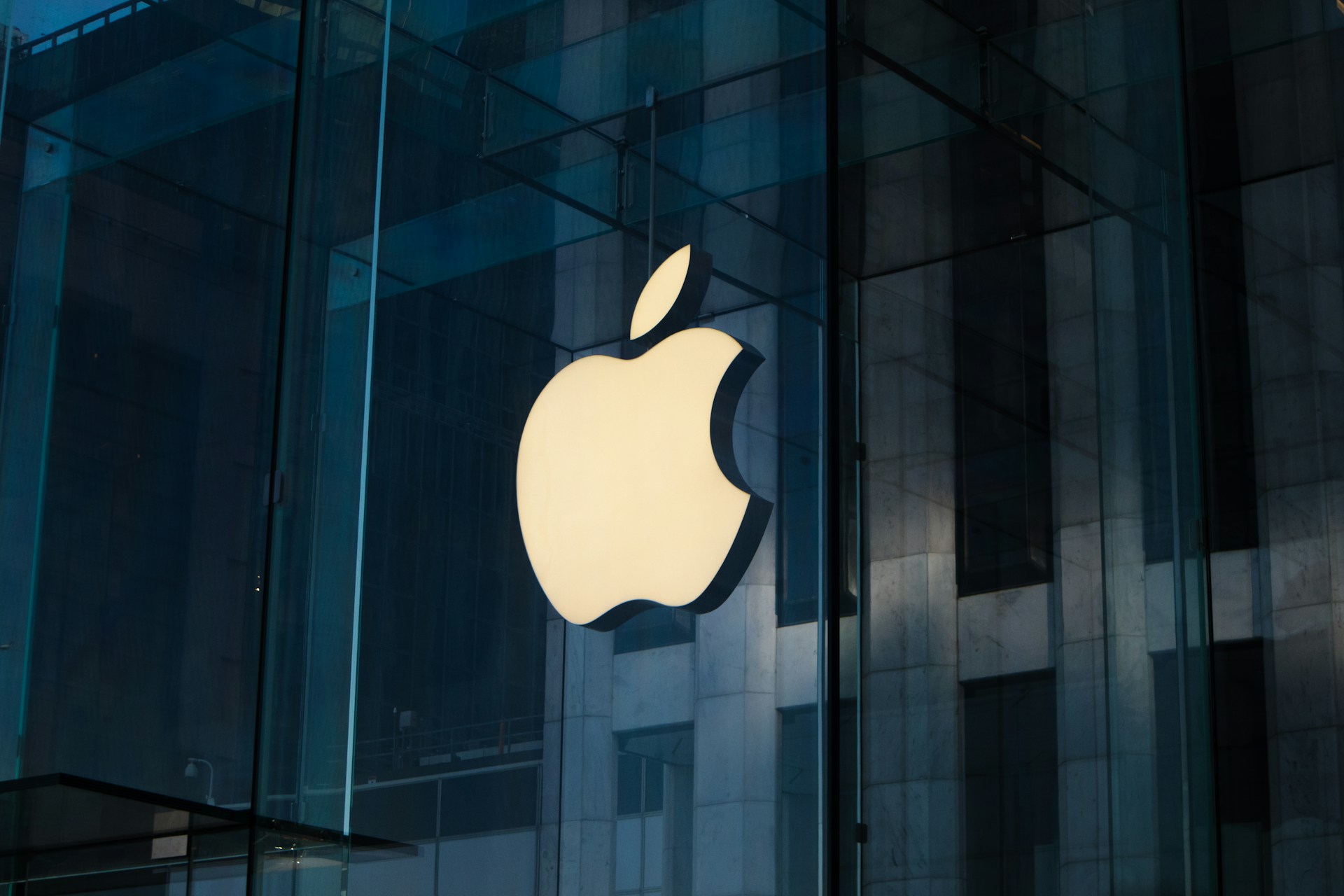 Apple company logo affixed to a glass wall