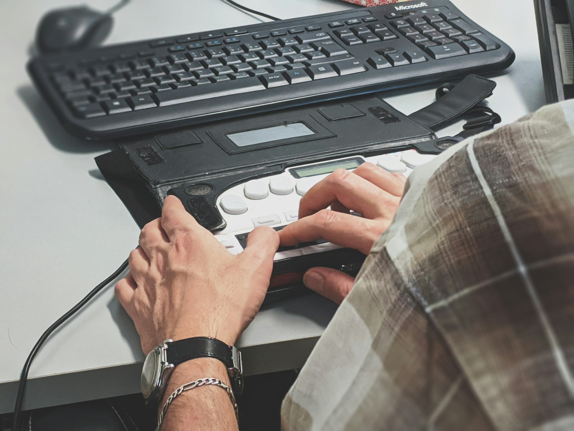 Person using a braille keyboard